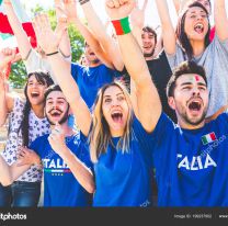 <p>Italian supporters celebrating at stadium with flags. Group of fans watching a match and cheering team Italy. Sport and lifestyle concepts.</p>