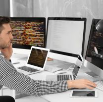 <p>Handsome young programmer working in office</p>